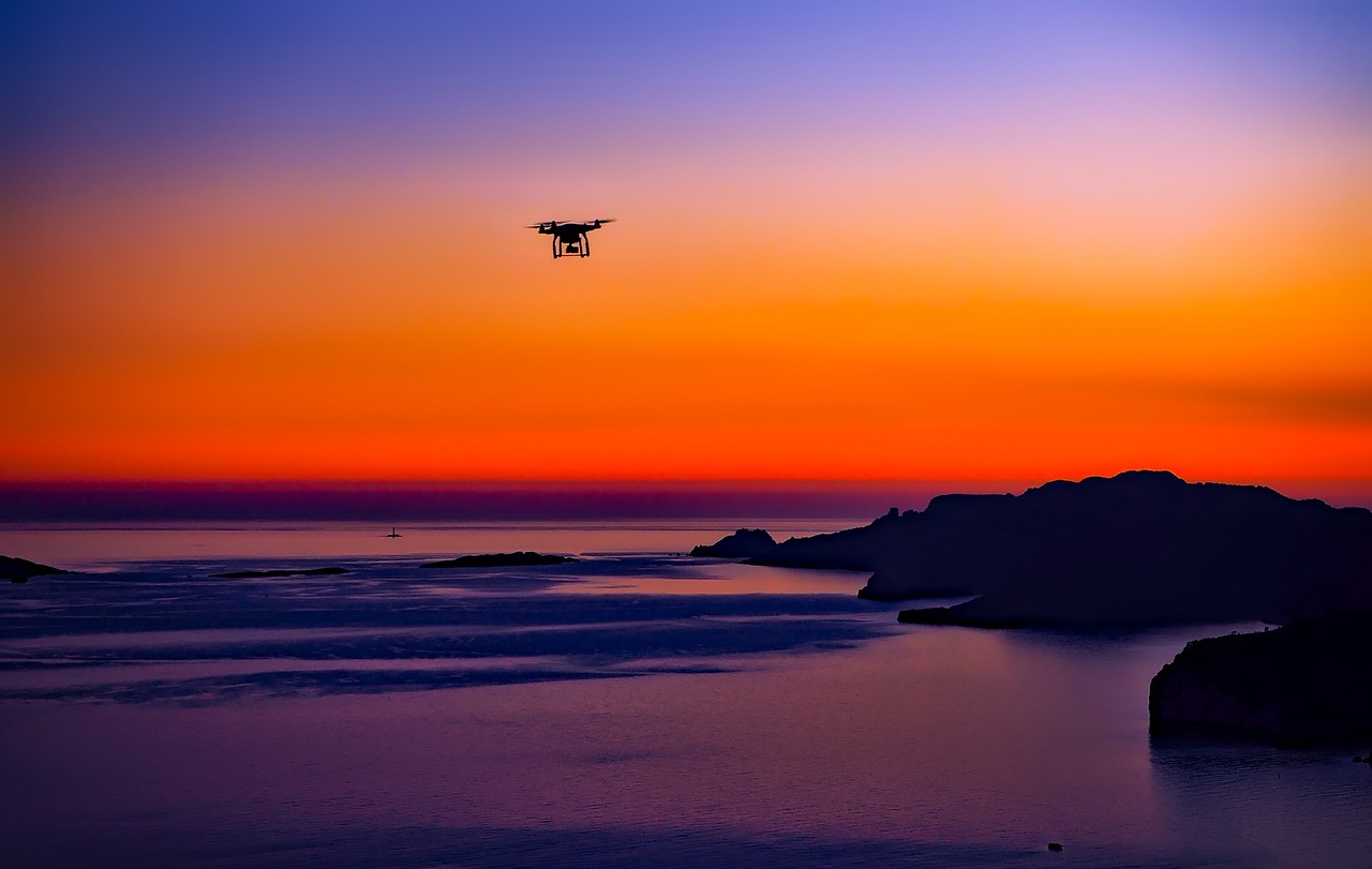 drone aerial ocean mountains sunset